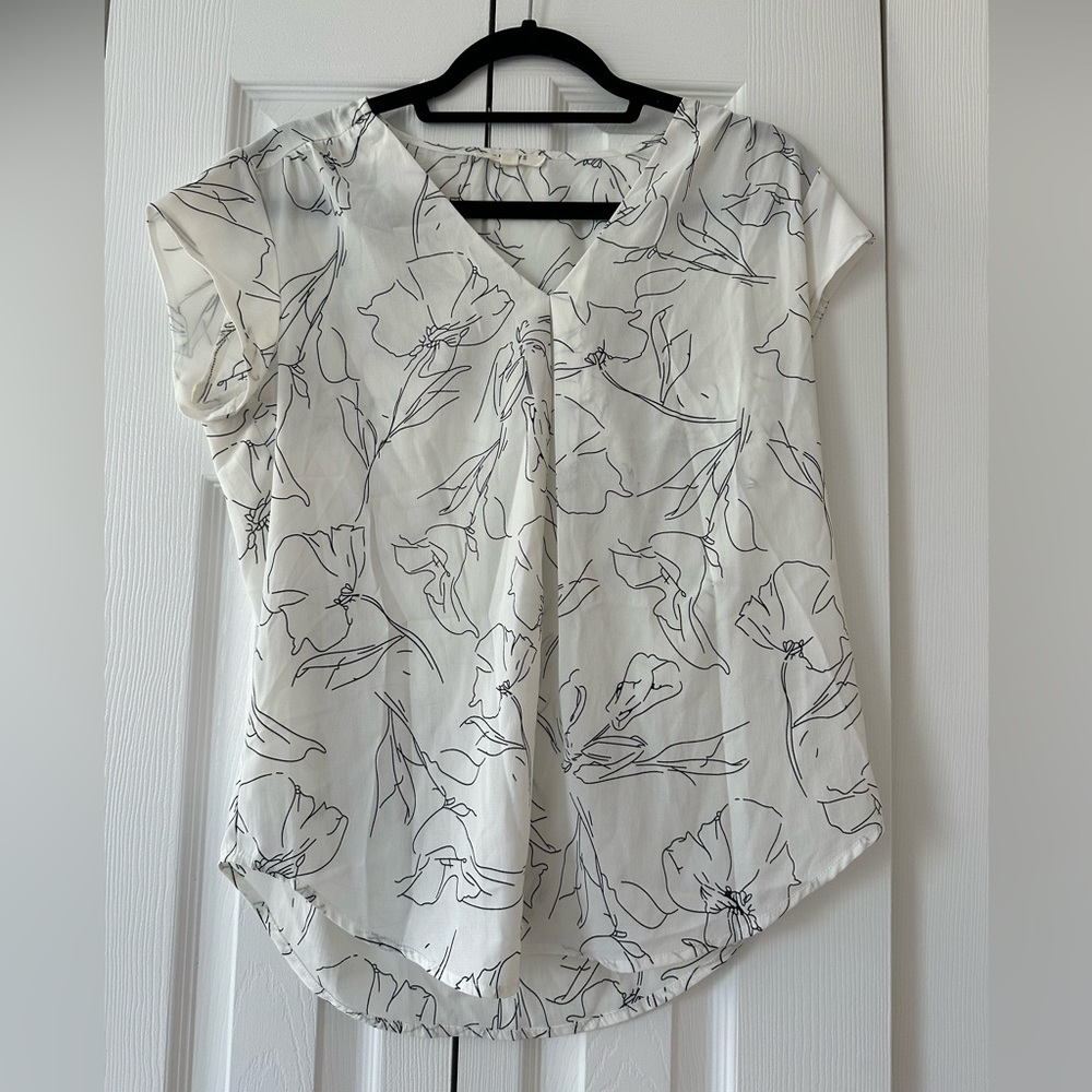 White blouse with floral details